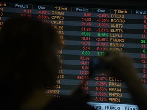 A man is silhouetted at the Stocks Exchange headquarters in downtown Sao Paulo, Brazil.