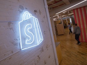 The logo of Shopify Inc. hangs on a wall at the company's office space in Toronto, Ontario