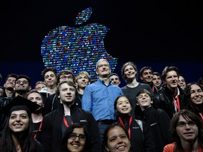 Tim Cook, chief executive officer of Apple Inc., centre, stands with WWDC 2016 Scholarship program winners in San Francisco, California