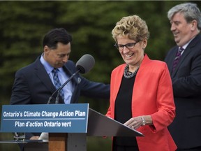 Ontario Premier Kathleen Wynne announces climate change policy with Ontario Minister of Economic Development, Employment and Infrastructure Brad Duguid, left, Ontario Minister of the Environment and Climate Change Glen Murray, right, in Toronto
