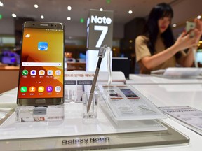 A woman tests a Samsung Galaxy Note7 smartphone at a Samsung showroom in Seoul