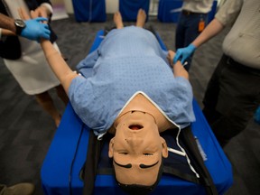A health simulator has its pulse taken at CAE headquarters.