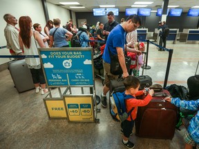 Passengers check-in at Newleaf, Canada’s latest discount airline before it’s inaugural flight out of Hamilton on July 25, 2016.