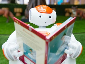 A robot poses as Westfield hosts an interactive artificial intelligence storytelling event for kids in London.