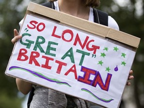 A demonstrator holds a placard that reads "So Long Great Britain" during a protest against the pro-Brexit outcome.