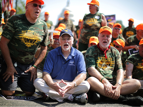 United Mine Workers of America President Cecil Roberts (C) joins about 100 members of the UMWA as they block traffic on Pennsylvania Avenue near the U.S. Capitol.