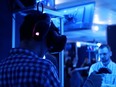 This screen grab from a promotional video shows a player wearing a headset and headphones while immersed in a game in one of the play pods at Ctrl V's Waterloo headquarters.