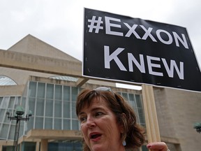 Activist Danna Miller Pyke protests across from Morton H. Meyerson Symphony Center where the Exxon Mobil annual shareholder meeting is taking place, in Dallas, Wednesday, May 25, 2016.