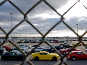 Cars in a lot beside the General Motors plant in Oshawa.