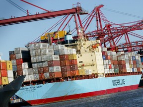 A container ship is unloaded at the Port of Melbourne. A consortium including a Canadian pension plan has won a 50-year-lease on the nation's biggest container and cargo port.