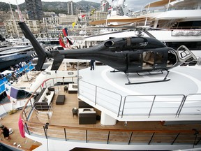 A Bell helicopter, manufactured by Textron Inc., sits on a helipad on on board the luxury yacht Voyager