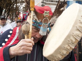 A Nadleh Whut-En band member performs a traditional song in the streets Vancouver Dec. 2, 2010 with other First Nation in protest to  the Enbridge Pipeline. Indigenous leaders signed the agreement today in Montreal and Vancouver.