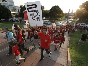 A line of protesters against the construction of the Dakota Access oil pipeline on the Standing Rock Reservation in North Dakota head to a unity rally on the west steps of the State Capitol late Thursday, Sept. 8, 2016, in Denver. Several hundred marchers walked from the four directions to the Capitol to take part in the rally against the oil pipeline. (AP Photo/David Zalubowski)
