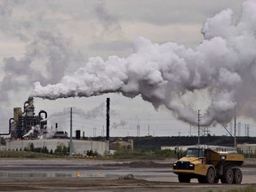 A dump truck works near the Syncrude oil sands extraction facility near the city of Fort McMurray, Alta., on June 1, 2014.