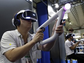 A visitor tries out a PlayStation VR headgear device at the Tokyo Game Show in Makuhari, near Tokyo, Japan.