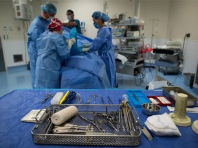 Sterile instruments are laid out as a patient is prepped at the Cambie Surgery Centre in Vancouver, B.C.