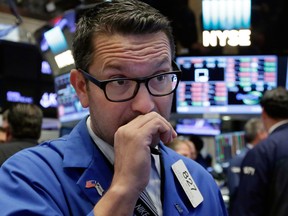 Wall Street was lower in choppy trading, pulled lower by Apple and healthcare stocks.