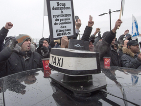 Taxi drivers take part in an anti-Uber protest at Trudeau International Airport in Montreal earlier this year.