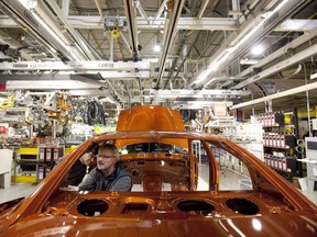 Chrysler Group LLC employees work on the assembly line during the production launch of Chrysler vehicles at the assembly plant in Brampton, Ont. January 7, 2011.