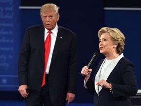 US Democratic presidential candidate Hillary Clinton and US Republican presidential candidate Donald Trump debate during the second presidential debate at Washington University in St. Louis, Missouri, on October 9, 2016.