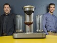 Entrepreneurs Ryan Close (left) and Bryan Fedorak (right) with their Bartesian cocktail maker in Kitchener, Ontario. Their new machine makes mixed cocktails using a pod system like many popular one-cup coffee machines.
