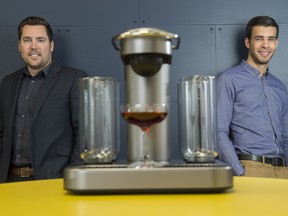 Entrepreneurs Ryan Close (left) and Bryan Fedorak (right) with their Bartesian cocktail maker in Kitchener, Ontario. Their new machine makes mixed cocktails using a pod system like many popular one-cup coffee machines.