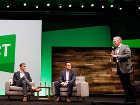 Gold medalist Michael Phelps, left, inspires attendees during a fireside chat with entrepreneur Bill Rancic and Intuit CEO Brad Smith at the third annual QuickBooks Connect on Tuesday, Oct. 25, 2016 in San Jose, Calif.