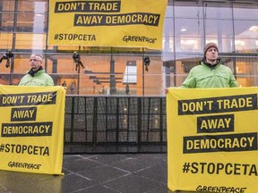 Greenpeace demonstrators hold protest banner outside a meeting venue of EU trade ministers at the EU Council building in Luxembourg.