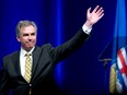 Jim Prentice waves after his speech at the Alberta PC Dinner in Calgary, Alberta