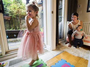 Kimberly Kelly watches her daughter Sadie Clapre as she holds her son Griffin in the small nursery she and her husband built in a corner of the their apartment living room, Vancouver.