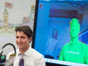 Prime Minister Justin Trudeau takes part in a virtual reality tour along with 3D printing technology at the new Google Canada Development headquarters in Kitchener, Ont.