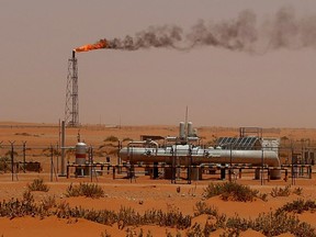 A flame from a Saudi Aramco oil installion known as "Pump 3" is seen in the desert near the oil-rich area of Khouris, 160 kms east of the Saudi capital Riyadh.