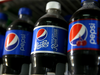 Bottles of Pepsi are displayed in a cooler at a convenience store