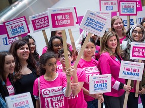 Caroline Riseboro, Plan International Canada's CEO (left), with the Honourable Rona Ambrose, Leader of the Official Opposition (right), and Plan International Canada Youth Ambassadors celebrate International Day of the Girl at the Toronto Eaton Centre, urging all girls, boys, women and men to stand up for gender equality and declare that #GirlsBelongHere.