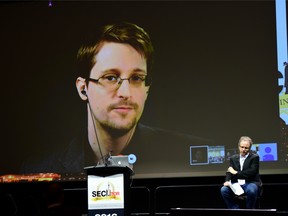 Michael Geist on stage while Edward Snowden speaks via video link at the cybersecurity conference SecTor.