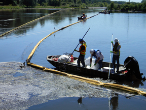 Workers clean an oil spill on the Kalamazoo River in Michigan in 2010.