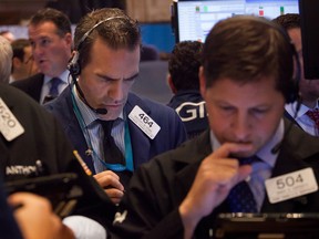 Wall Street opened higher today as a flurry of deal activity boosted investor confidence, but the TSX slipped into the red as oil fell.