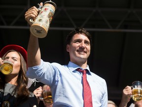Prime Minister Justin Trudeau celebrates after tapping the keg at the opening ceremonies for Oktoberfest in Kitchener, Ont.