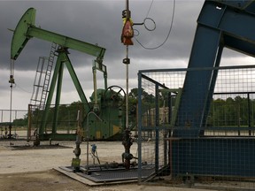 A pumpjack, left, operates at the Vermilion Energy Trust pipeline and storage site in Vaudoy-en-Brie, near Paris, France