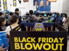 Shoppers swarm Black Friday sales at Best Buy last year.