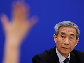 Li Fei, deputy secretary general of the National People's Congress Standing Committee, looks at a reporter raising the hand to ask for a question during a press conference at the Great Hall of the People in Beijing, Monday.