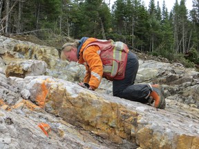 Tanya Tettelaar, Marathon Gold Exploration Manager examining a new gold occurrence on the shore of Valentine Lake