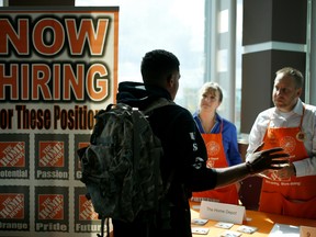A job seeker speaks with recruiters from The Home Depot at a Recruit Military veterans job fair in Cleveland, Ohio, U.S., on Thursday, Sept. 1, 2016.