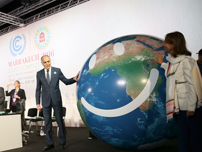 French Environment Minister Segolene Royal, right, and conference president Salaheddine Mezouar stand by a globe during the opening session of the Climate Conference in Marrakech, Morocco, Monday.