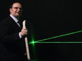 George Palikaras, founder and CEO of Metamaterial Technologies Inc., demonstrates how lasers are blocked and defected off a windscreen with the metaAIR optical filter applied.