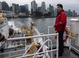 Prime Minister Justin Trudeau stands on board the Canadian Coast Guard ship Sir Wilfrid Laurier, during a tour of the harbour in Vancouver, B.C.