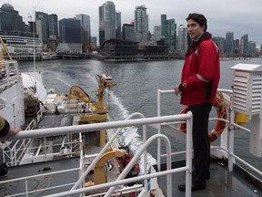 Prime Minister Justin Trudeau stands on board the Canadian Coast Guard ship Sir Wilfrid Laurier, during a tour of the harbour in Vancouver, B.C., on Monday. Following the tour, Trudeau announced a new oceans' protection initiative funded by the federal government.
