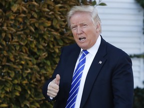 President-elect Donald Trump gives the thumbs-up as he arrive at the Trump National Golf Club Bedminster clubhouse
