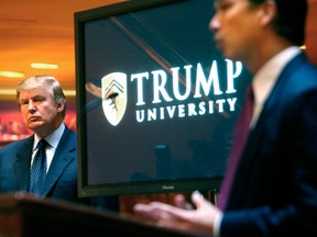 Donald Trump, left, listens as Michael Sexton introduces him at a news conference in New York where he announced the establishment of Trump University in 2005.