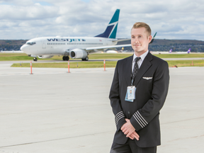 A pilot films a TV commercial on the tarmac at WestJet airlines